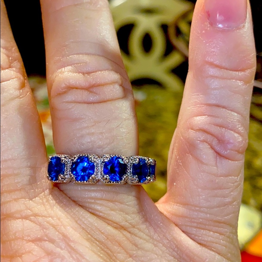 Size 8 Blue sapphire surrounded by white topaz